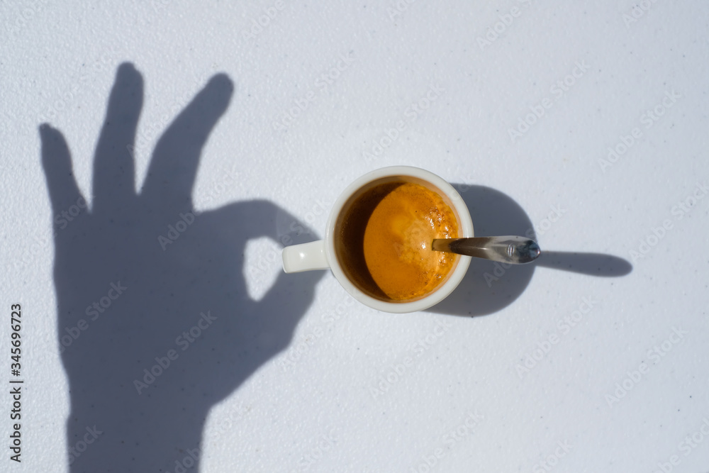 Cup of coffee in the morning light, sunlight shadow, concept, top view hand shadow drinking a real coffee, coffee background Cup of coffee in the morning light, sunlight shadow, concept, top view hand shadow drinking a real coffee, coffee background
