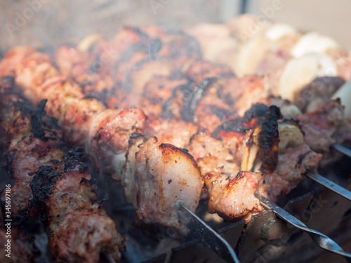 Shish kebab is prepared on the grill. Outdoor recreation. Beef meat.