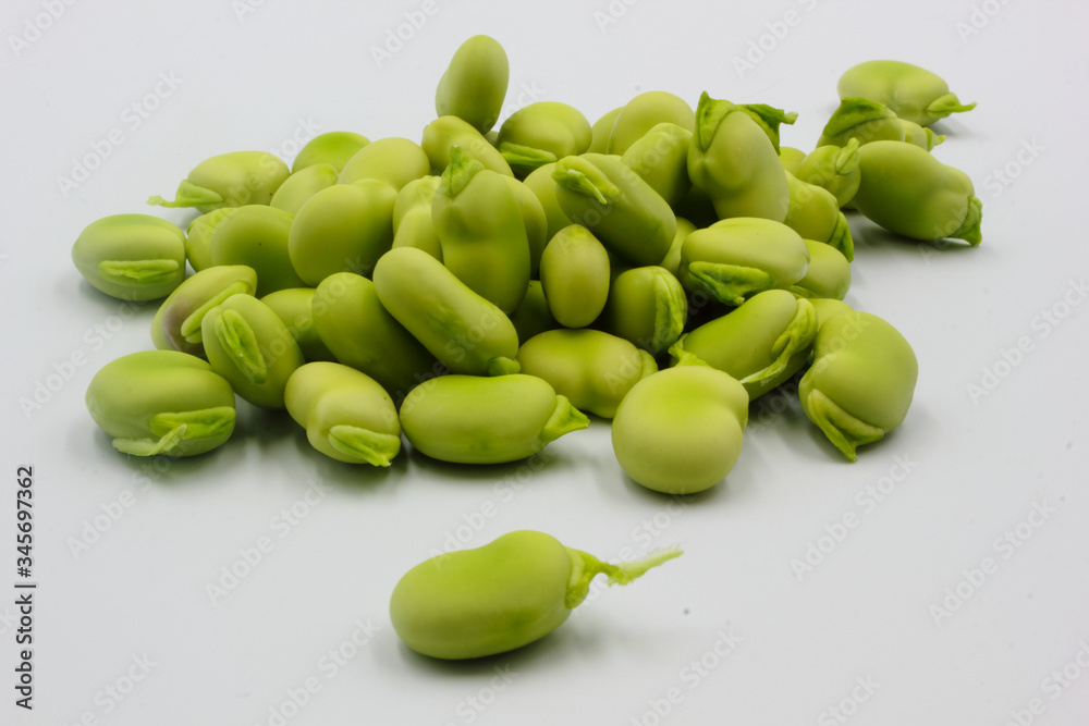 pile of fresh shelled broad beans isolated on a white background