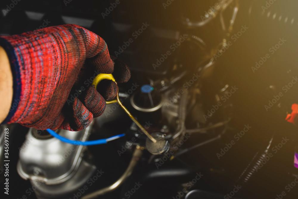 Mechanics hand hold dipstick transmission oil level gauge with yellow