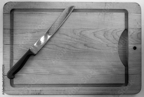 bread knife on chopping board in black and white