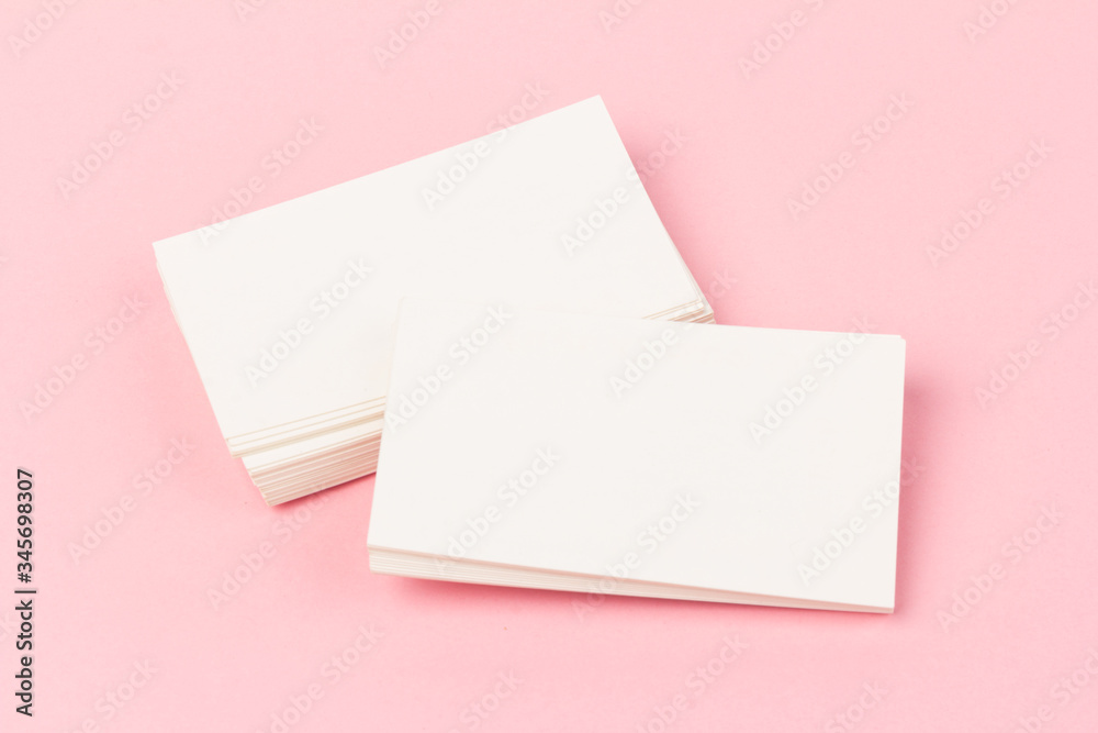 white blank business cards on pink background in close-up white blank business cards on pink background in close-up