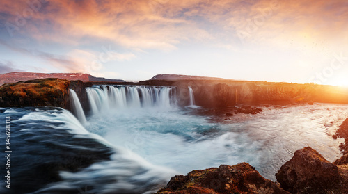 Amazing nature scenery. Godafoss waterfall with colorful sky during sunset. Iceland, Europe. Impressive Athmospheric landcape. Fantastic foggy morning. Popular touristic locations © jenyateua