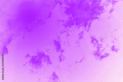 Beautiful violet sky background with clouds. Toned photo