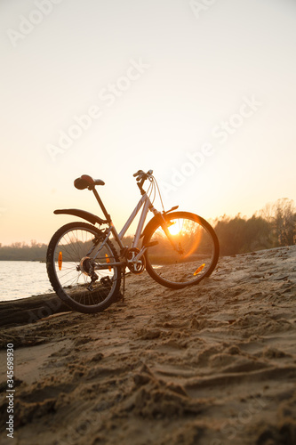 bike on the beach in sunset sunlight. bicycle riding. Sport lifestyle. Eco friendly transport. Bicycle Parked In Dunes Near The Sea. Camping Trip. Enjoying of freedom & nature on bicycle.