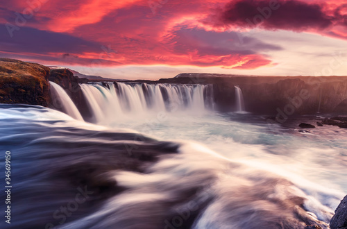 Gorgeous nature scenery. Godafoss waterfall with colorful overcast sky during sunset. Iceland  Europe. Impressive Athmospheric landcape. Fantastic foggy morning. Popular touristic locations.