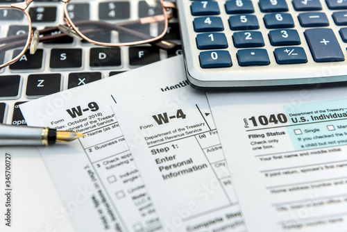 Financial time tax form with laptop and calculator. Office paperwork