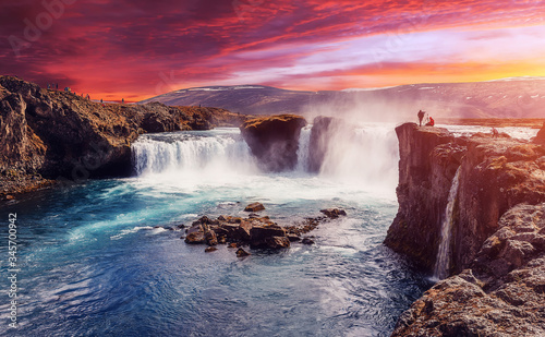 Godafoss waterfall with dramatic colorful sky during sunset  Icelandic nature scenery Amazing long exposure scenery of famous landmark in Iceland. Creative image best locations for photographers