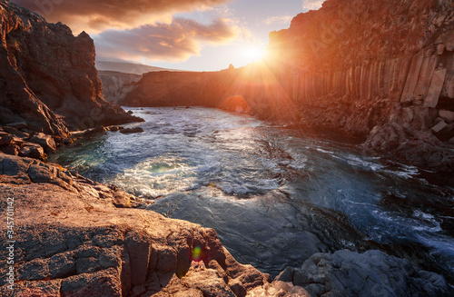 Scenic image nature of Iceland. Amazing tipical Icelandic scenery in summer. The most beautiful conyon with black basalt columns and river under sunligt in Iceland. Amazing nature landscape.