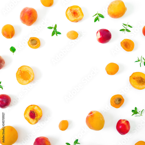 Fruit frame of ripe apricot and peaches with leaves isolated on white background. Top view
