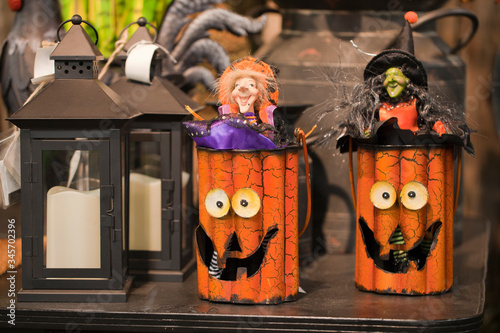 Colorful Halloween decorations on a display. Jack O' lanterns and retro lanterns against a blurry background.