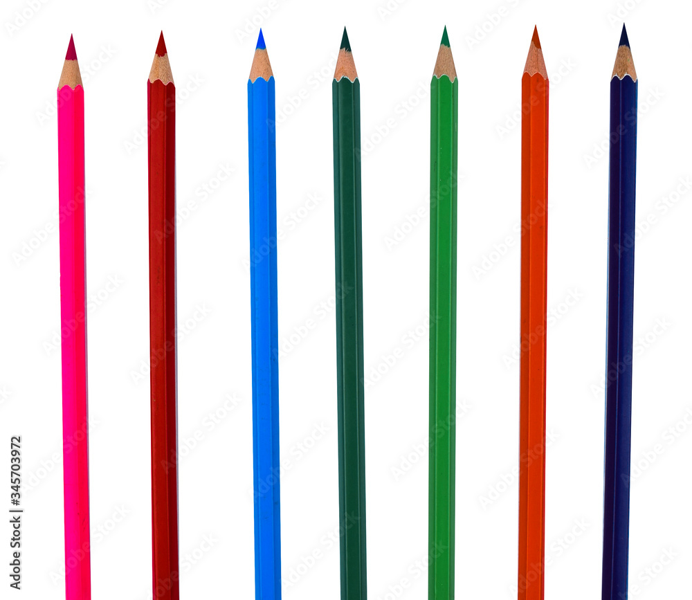 Different color wood pencil crayons placed in a row on a white background Different color wood pencil crayons placed in a row on a white background