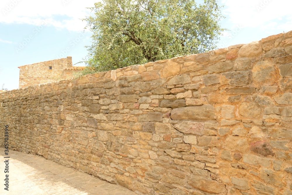 Footpath along stone wall