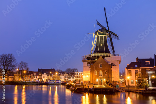 Holland, Haarlem canals. view of canal with traditional windmill, night view