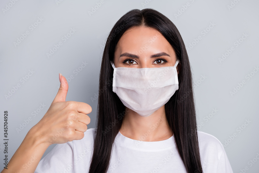 Close-up portrait of nice attractive lovely content healthy straight-haired girl showing thumbup trust solution health quarantine measure sars isolated on light grey pastel color background Close-up portrait of nice attractive lovely content healthy straight-haired girl showing thumbup trust solution health quarantine measure sars isolated on light grey pastel color background