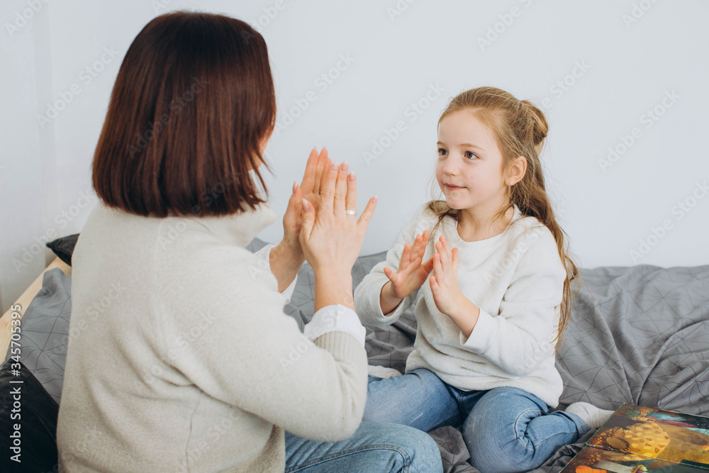Happy loving family. Mother and her daughter girl play in children room. Funny mom and lovely child having fun indoors.