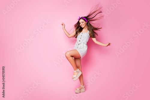 Full length body size view of her she nice-looking attractive charming dreamy cheerful straight-haired girl having fun wind blowing hair good mood weather isolated on pink pastel color background