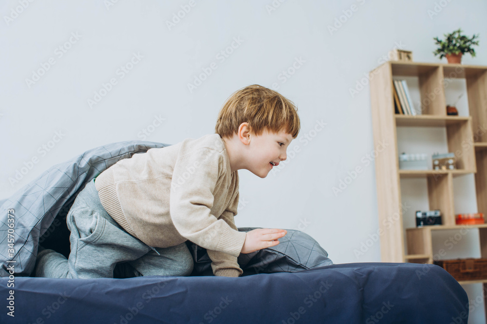 Cute little boy on bed at home Cute little boy on bed at home