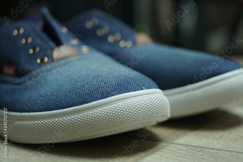 new jeans sneakers close up © taraskobryn