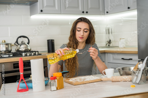 A woman kneads the dough with different ingredient. Healthy family food