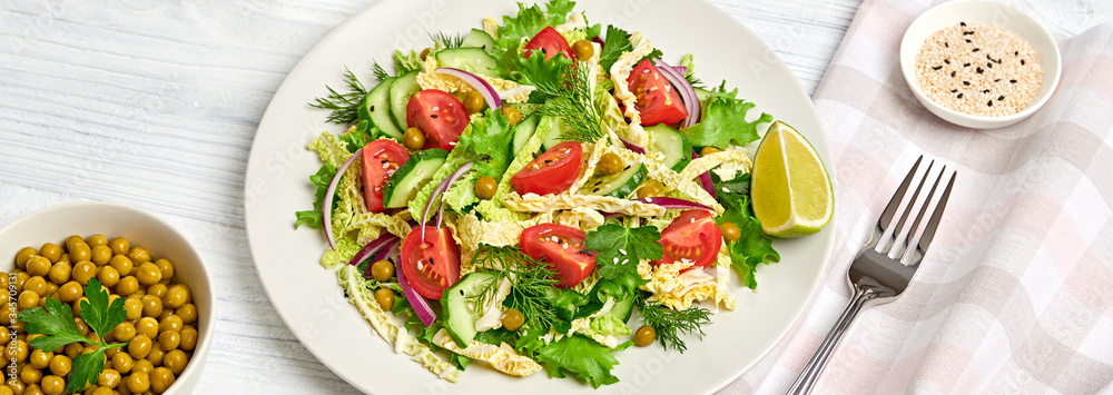 Savoy cabbage salad with cherry tomatoes, cucumeber on dish. Healthy summer salad vegetarian meal concept. Tasty mixed leaves, tomatoes and mix vegetable salad on white wood Savoy cabbage salad with cherry tomatoes, cucumeber on dish. Healthy summer salad vegetarian meal concept. Tasty mixed leaves, tomatoes and mix vegetable salad on white wood