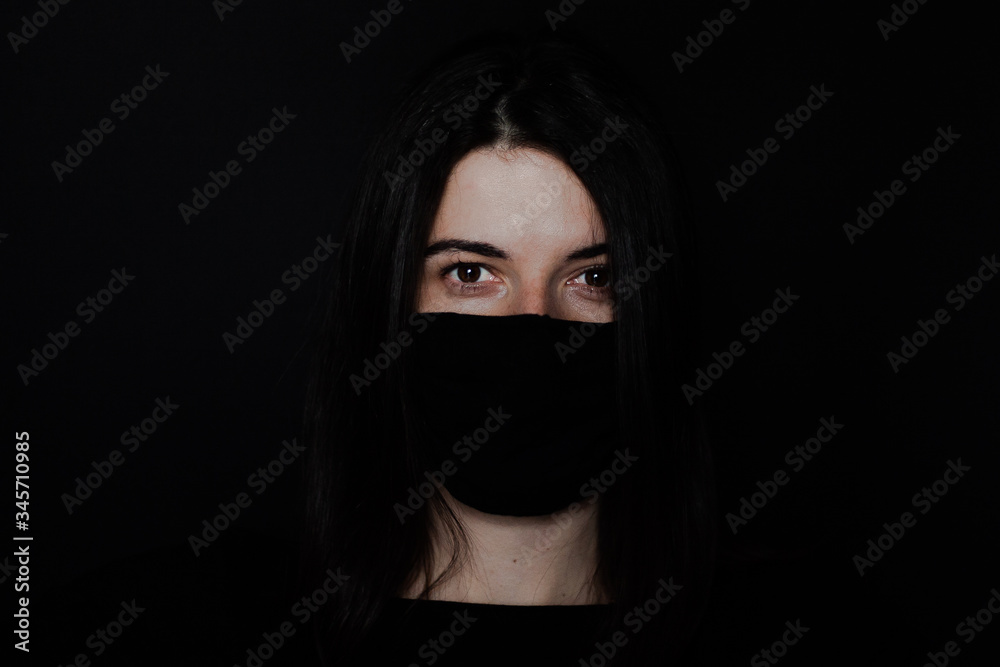 Young girl on black background in protective mask. Girl with black hair and a red face mask against
coronavirus disease. Problem of pandemic epidemic Coronovirus covid-19. Stay at home concept. Young girl on black background in protective mask. Girl with black hair and a red face mask against
coronavirus disease. Problem of pandemic epidemic Coronovirus covid-19. Stay at home concept.