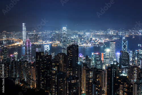 Filtered aerial night view on Hong Kong - skyscrapers from the the Peak . Amazing illuminated city
