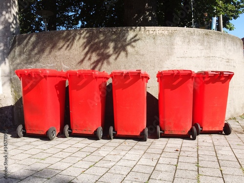 Red Recycling Bins On Street Against Wall