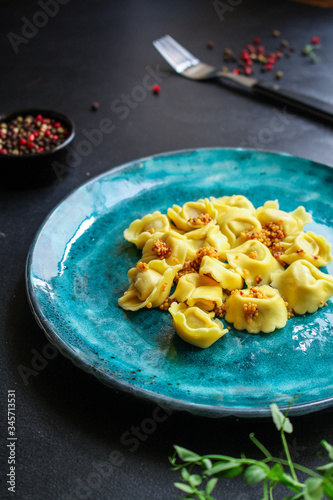 tortellini, pasta with filling (ravioli or dumplings)
second course
Menu concept. food background. top view copy space for text