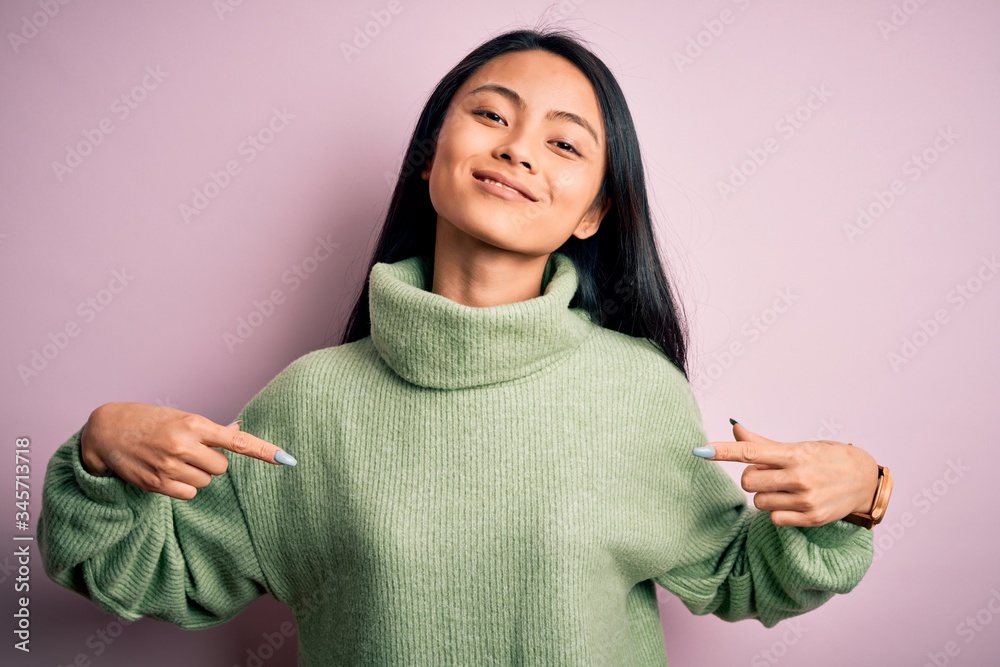 Young beautiful chinese woman wearing turtleneck sweater over isolated pink background looking confident with smile on face, pointing oneself with fingers proud and happy. Young beautiful chinese woman wearing turtleneck sweater over isolated pink background looking confident with smile on face, pointing oneself with fingers proud and happy.