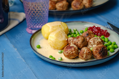 .Swedish meatballs with potatoes on blue wooden table