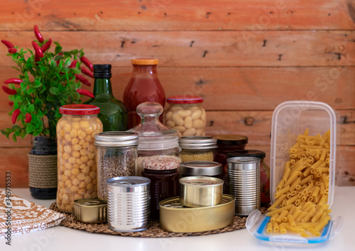 Small storage of canned and preserved non-perishable food useful to a small family quarantined due to coronavirus infection. Stay home to avoid contagion