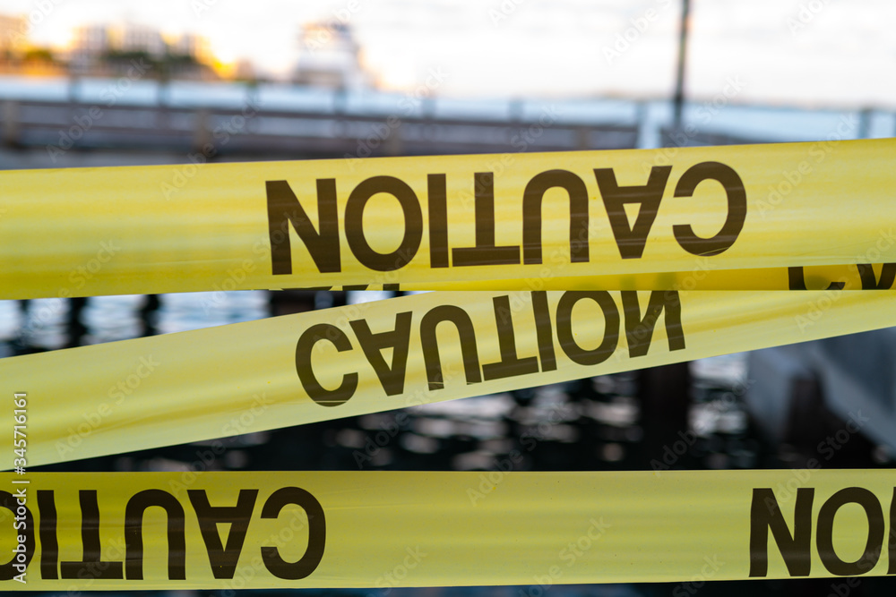 Obraz premium Yellow Caution USA Tape of COVID-19. Coronavirus Outbreak of Quarantine Area, Infection Virus Disease, Risk Area Zone. Biohazard. Lockdown quarantine. Miami Florida Closed. Health Protection Concept.