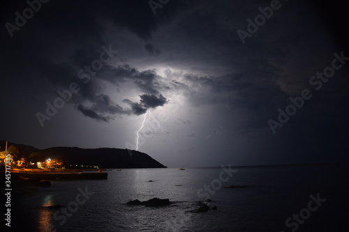 Thunder crashing down on hillside next to the sea in Mount Athos