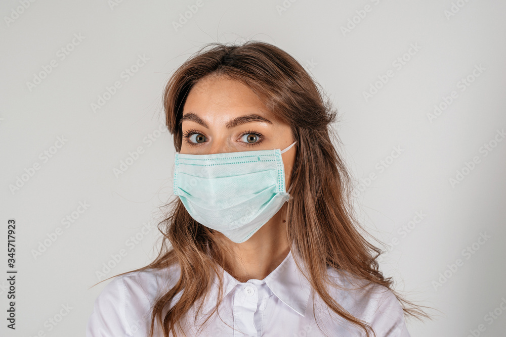 Woman wearing medical mask close up portrait on the white background Woman wearing medical mask close up portrait on the white background