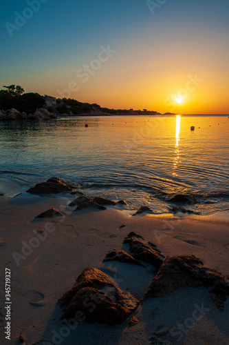 A landscape with relaxing colors that are reflected on the calm sea of       dawn in the summer day  in Sardinia Italy