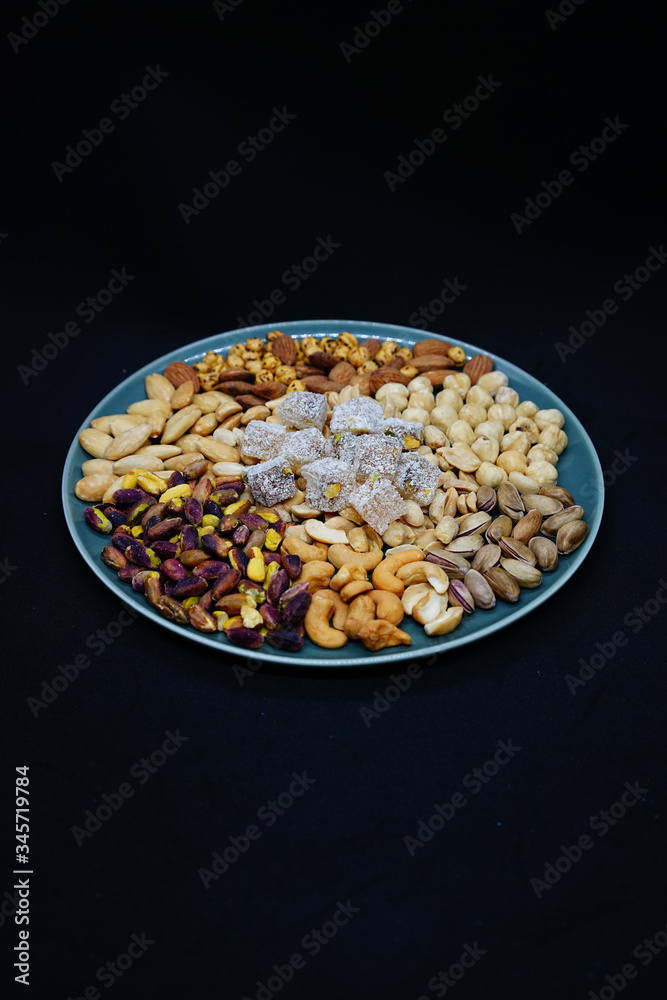 mixed nuts from above. Nuts of granite on a black background. Nuts shot from the top. nuts on a black background. peanut, cashew, roasted chickpea, hazelnut, pistachio, almond, roasted chickpea. mixed nuts from above. Nuts of granite on a black background. Nuts shot from the top. nuts on a black background. peanut, cashew, roasted chickpea, hazelnut, pistachio, almond, roasted chickpea.
