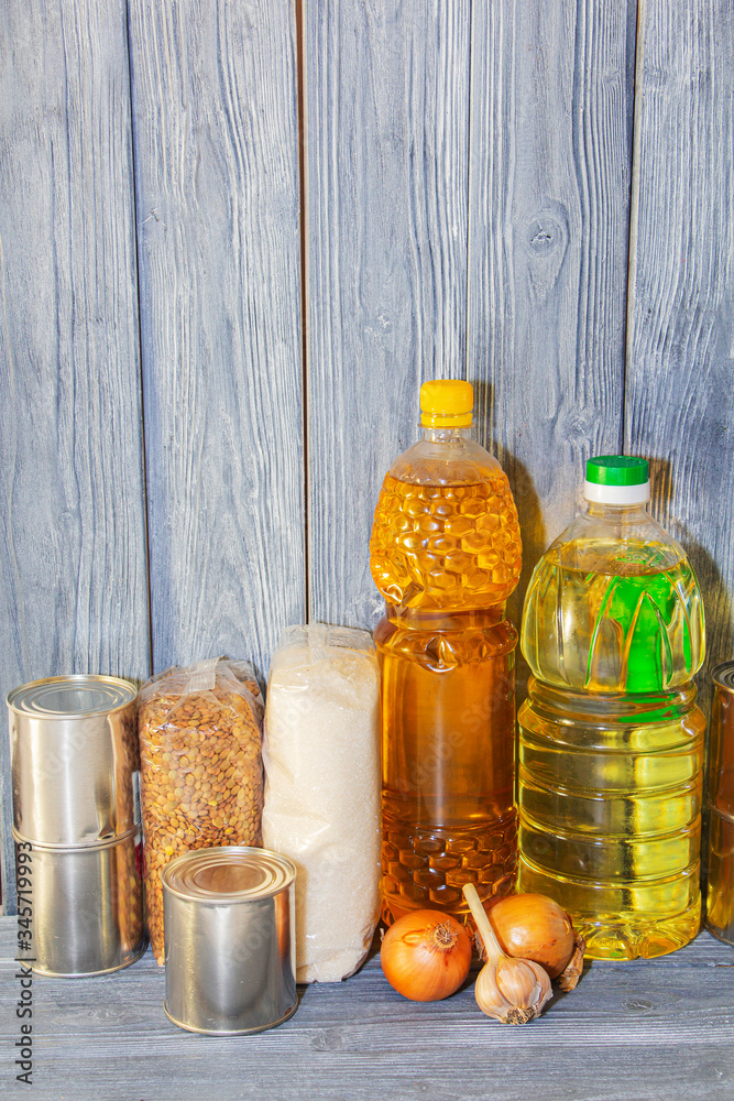 canned food and various cereals on a wooden shelf, food crisis