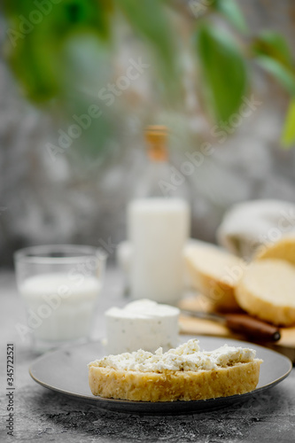 Healthy breakfast with homemade yeast-free bread, soft cheese and milk