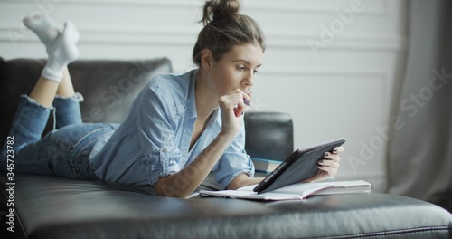 Young woman using digital tablet computer in home photo