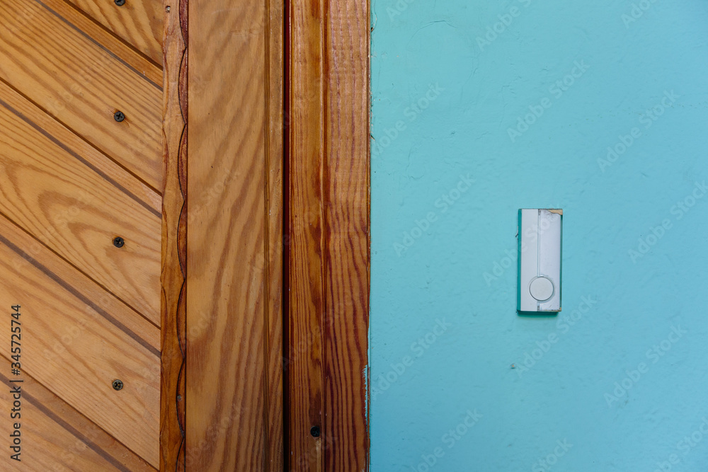 bell switch button on the wall with door