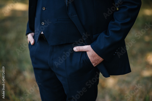 Hands of a man in the pockets of his trousers close-up