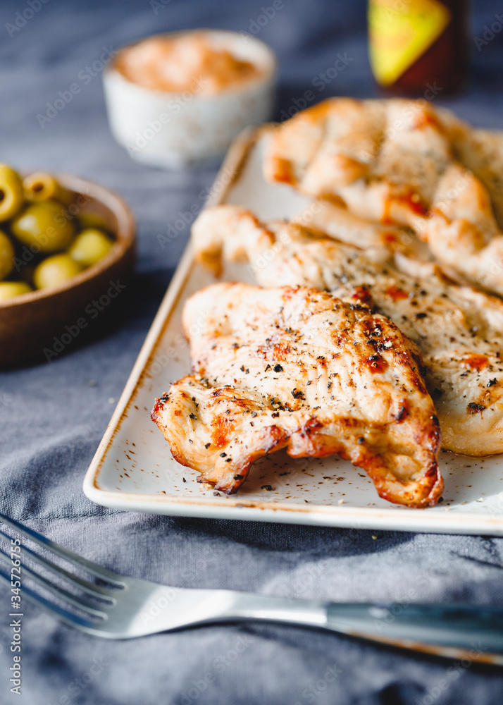 Grilled turkey escalopes with hot sauce on a table. Grilled turkey escalopes with hot sauce on a table.