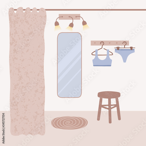 Trying swimsuit, bra and pants in the fitting room. Summer shopping: buying clothes at lifestyle boutique. Dressing room interior in neutral pastel brown colors for poster. Swimwear on the hanger. 