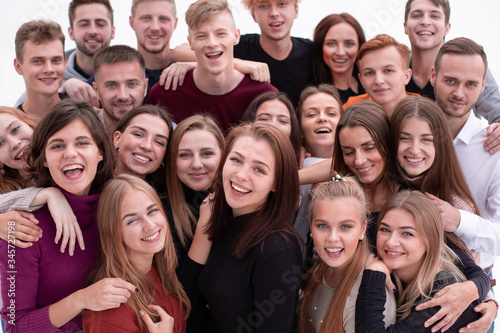 group of confident young people looking at the camera and showing their success