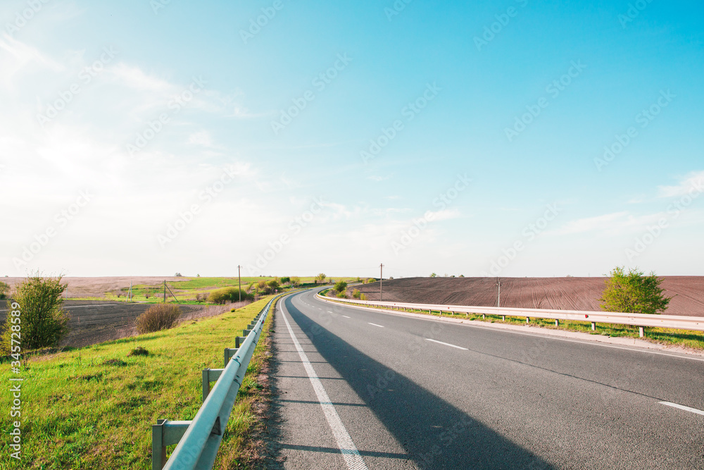 Fototapeta premium speed highway through the field. asphalt-paved road