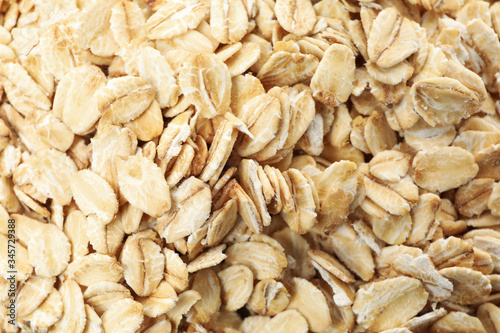 Oatmeal flakes texture on whole background, close up