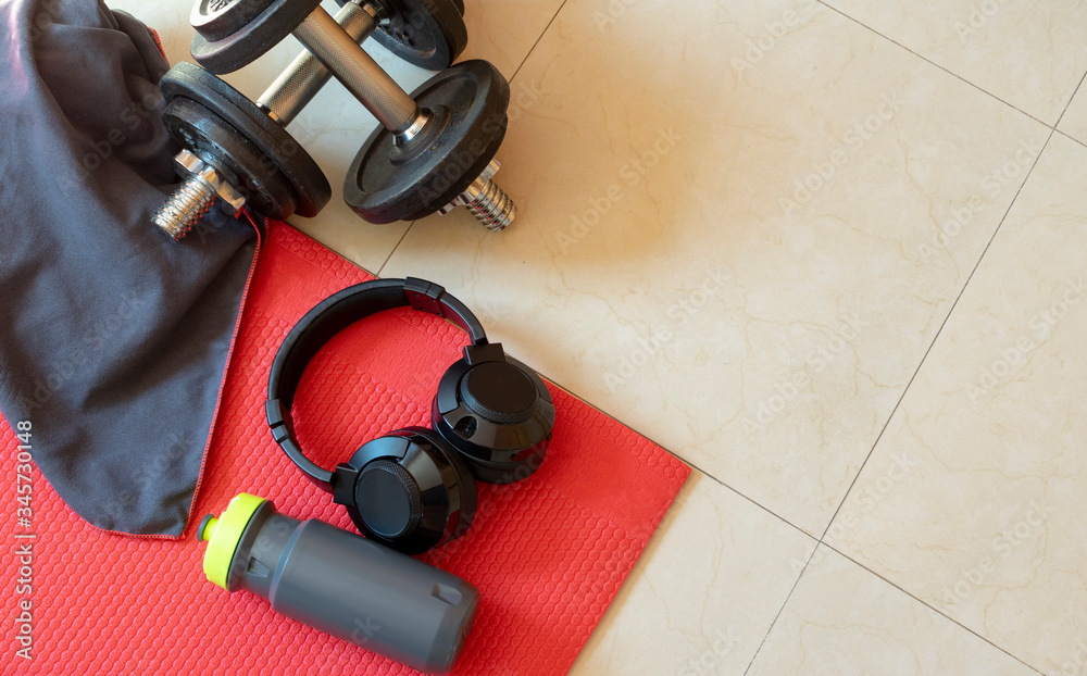 Sports equipment on floor background. Sports accessories, sports equipment, top view. Gym at home.