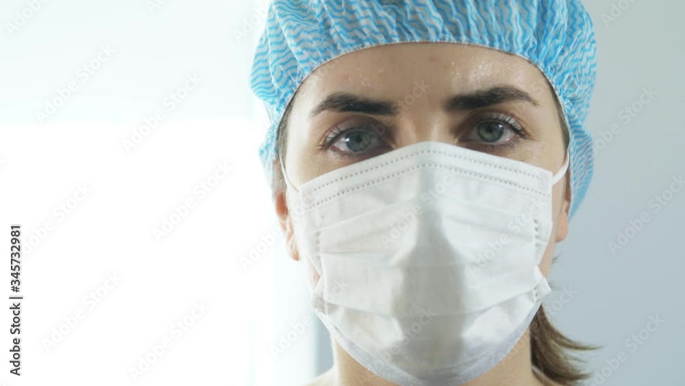 health, medicine and pandemic concept - close up of sad young female doctor or nurse wearing goggles and face protective mask for protection from virus disease health, medicine and pandemic concept - close up of sad young female doctor or nurse wearing goggles and face protective mask for protection from virus disease