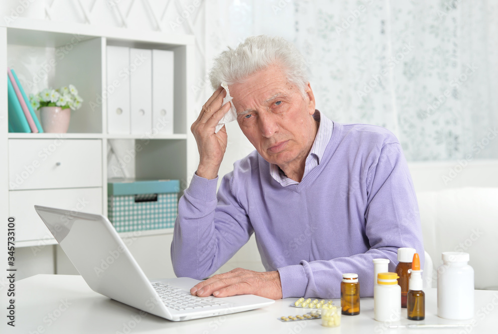 Portrait of sad sick senior man using laptop Portrait of sad sick senior man using laptop